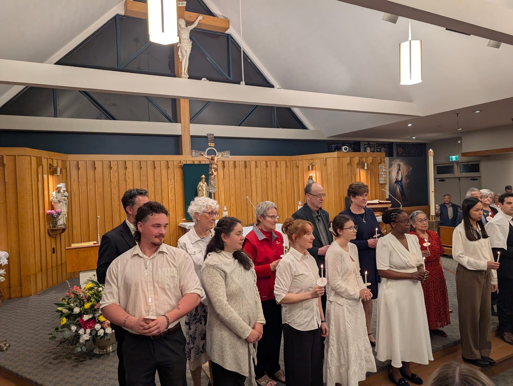 The congregation standing with candles inside St. Patrick’s during the Easter Vigil